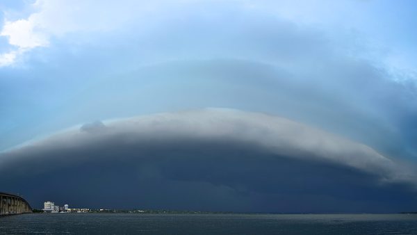 A storm with a shelf cloud moves eastward over the Indian River Lagoon from Cocoa, Florida, USA